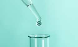 A dropper releasing a drop with a dollar sign into a beaker