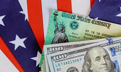 treasury notes and dollar bills sit atop a US flag