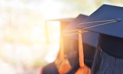 Row of students at a graduation wearing caps
