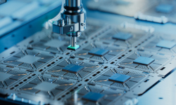 A robotic arm installing a semiconductor