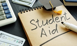 A notepad with the words student aid written on it