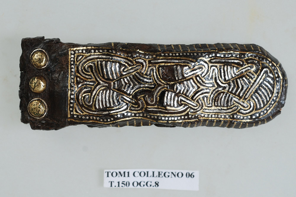 Ancient DNA Study Provides Insight on Genetic Diversity of Post-Roman Elites, Collegno, tomb no. 150. End element of belt for weapon suspension in iron with silver and brass inlay.