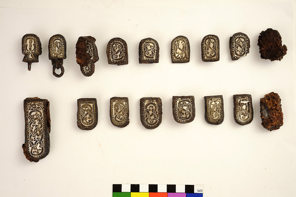 "Ancient DNA Study Provides Insight on Genetic Diversity of Post-Roman Elites, Collegno, tomb no. 150. End element of belt for weapon suspension in iron with silver and brass inlay."