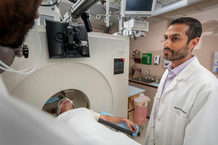 Image: Manu Goyal oversees a brain scan.