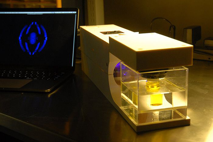 The 3D printer works by shining changing patterns of light through a rotating vial of liquid.