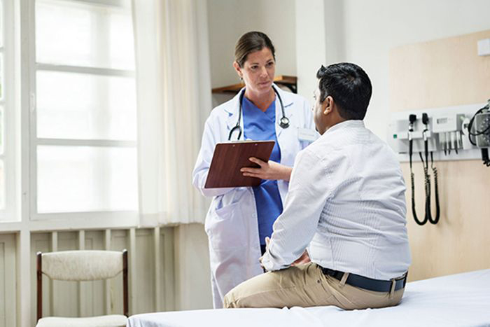 Image: Doctor speaking to patient.