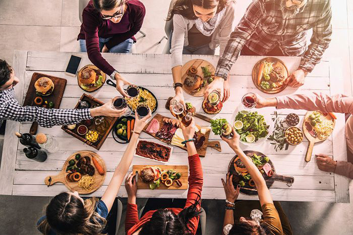 Friends sitting around a table, sharing a meal