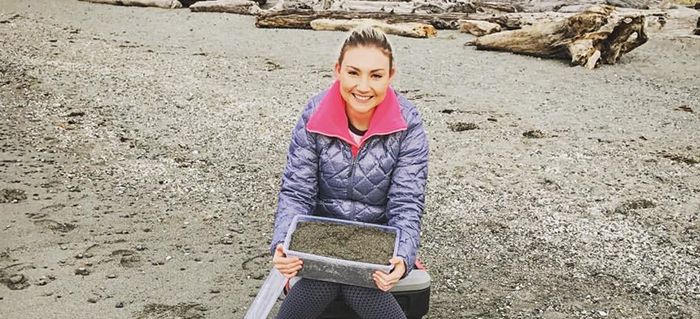 Oceanography senior Frances Eshom-Arzadon collects beach sediment at Edmonds Marina Beach.