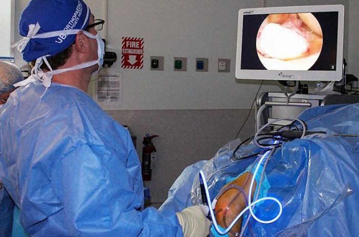 Doctor performing knee surgery
