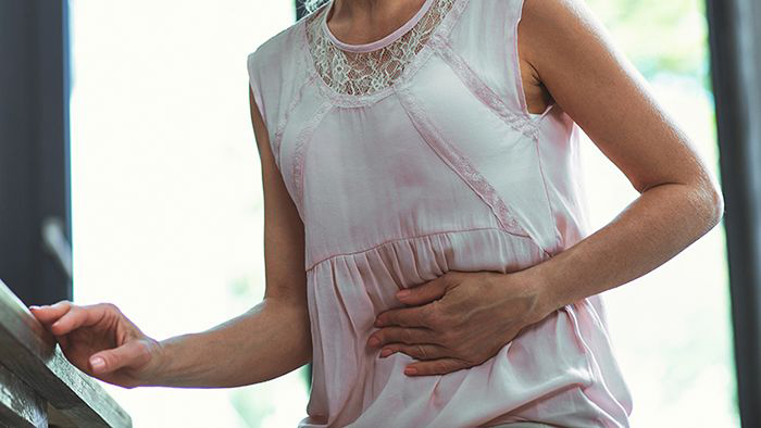 Image of woman holding her stomach