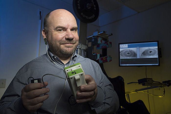 Jorge Serrador with the electrical stimulator he developed.