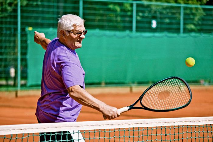 Senior playing tennis
