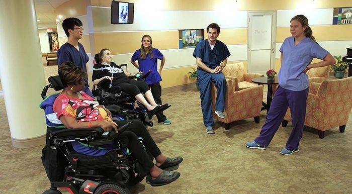 Tulane engineering students talking to ALS patients