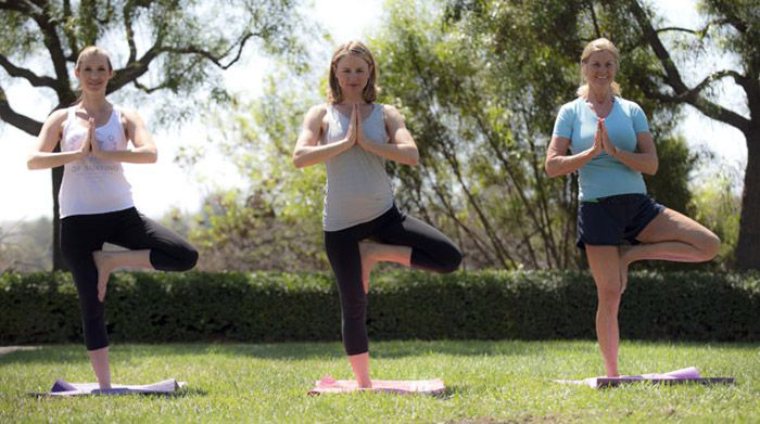 Image of three women practicing yoga