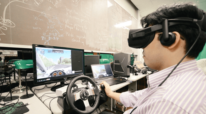 Researcher simulating self-driving car experience.