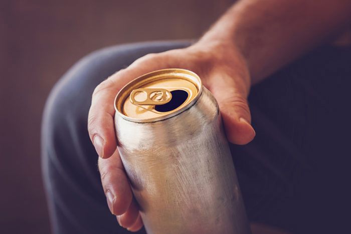 Image of man holding beer can