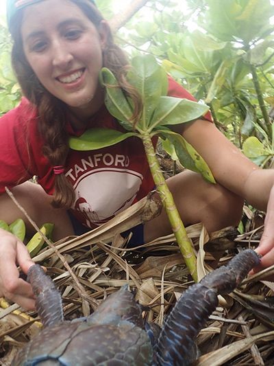 Biology graduate student Elora H. López holds a crab 