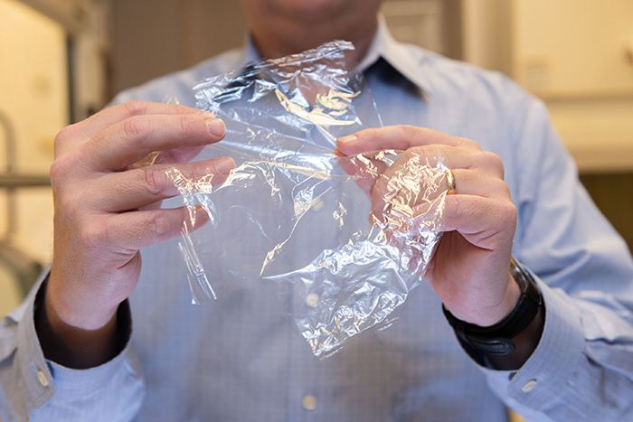 Image: J. Carson Meredith holds the new packaging material