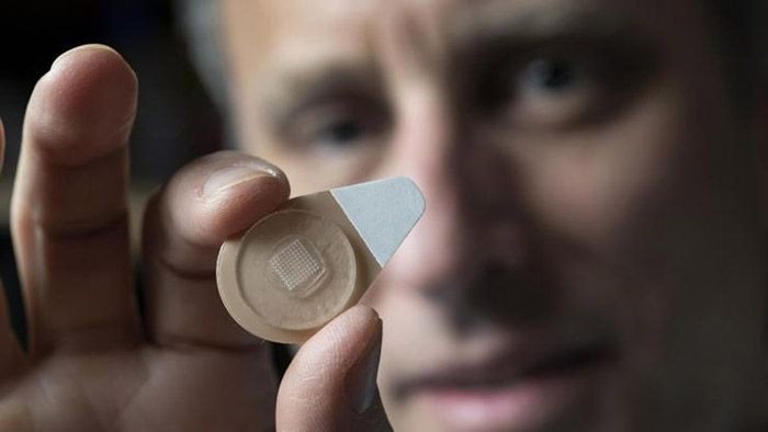 Regents Professor Mark Prausnitz holds an experimental microneedle contraceptive skin patch.