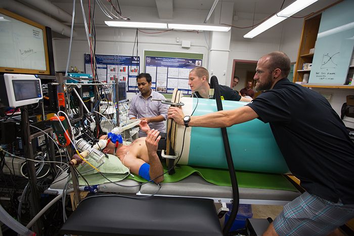 University at Buffalo researchers prepare a subject for a lower body negative pressure procedure that simulates blood loss.
