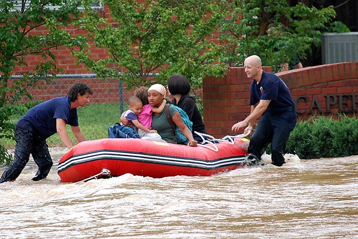 First responders rescuing resident from flooding