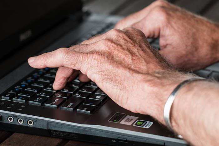 Image of man typing on a computer keyboard