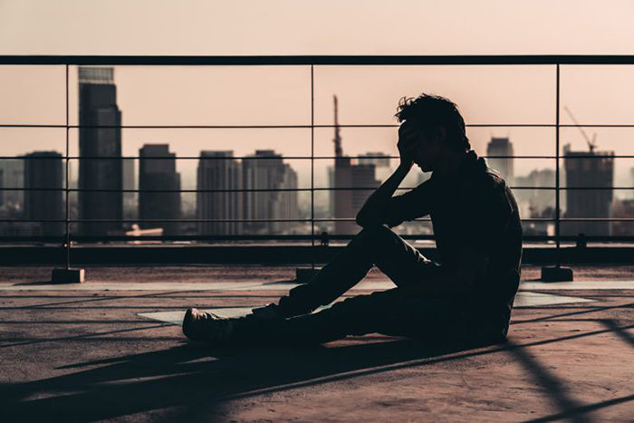 Young man sitting on roof top
