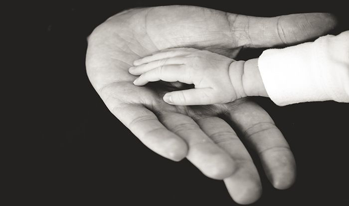 Image of child and adult hands