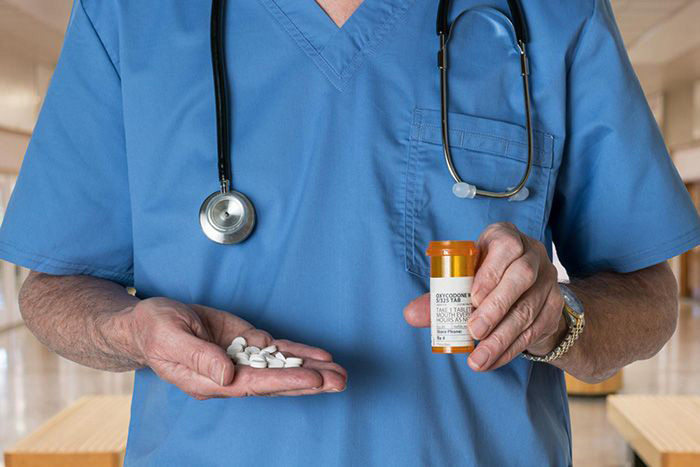 Health worker holding pills
