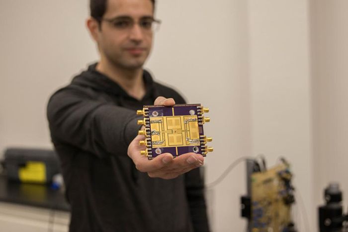 Graduate student Hossein Jalili displays the millimeter-wave/terahertz phased array chip.