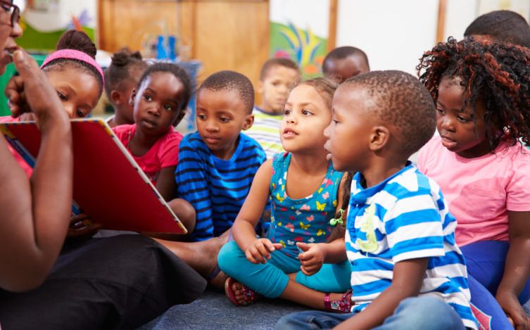 Children reading with teacher