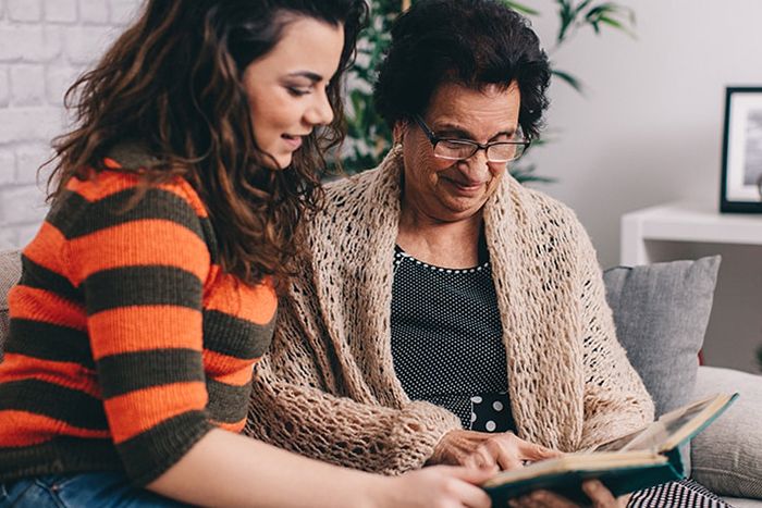 Daughter reading with mother