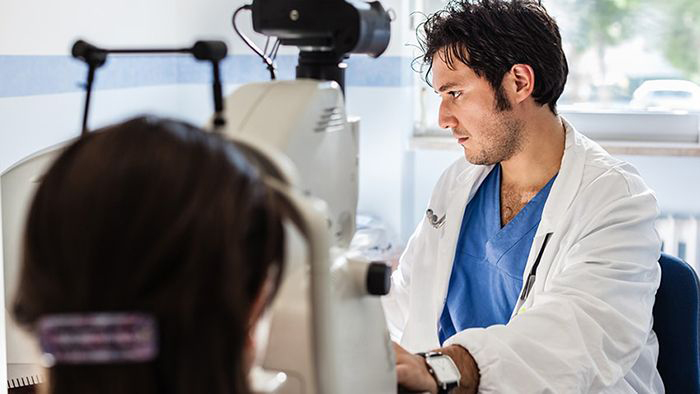doctor giving eye exam