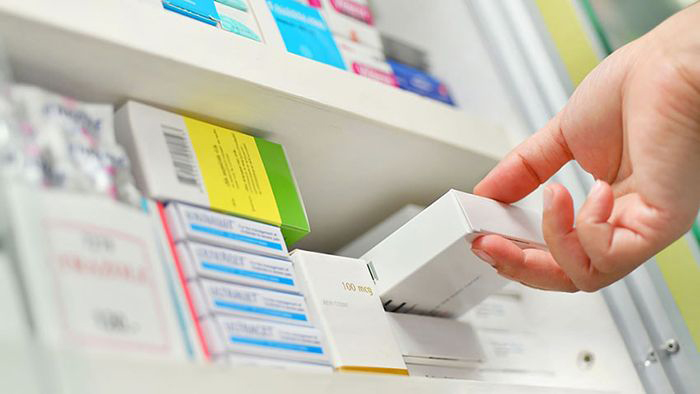 Image: Taking medicine from a shelf