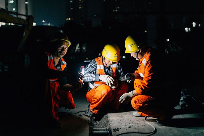 Utility workers at night