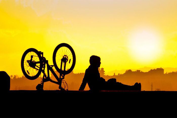 Rider sitting beside bike