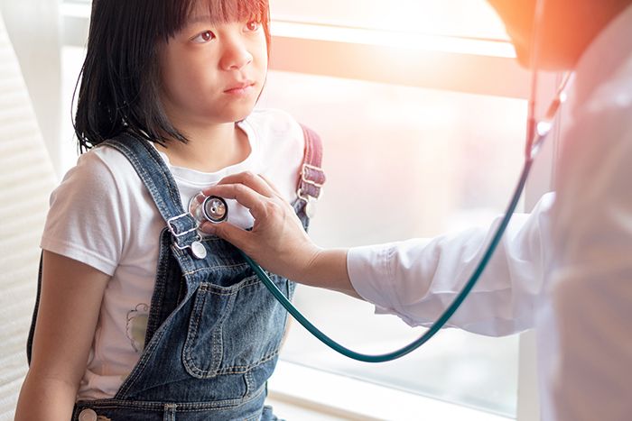 Doctor listening to child's lungs