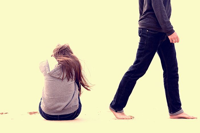 Tenn boy walking away from teen girl