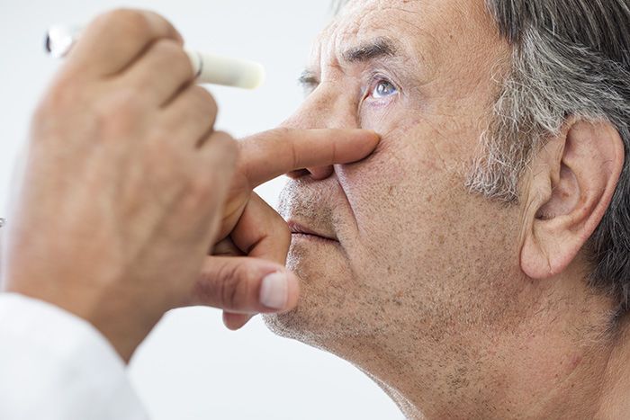 Doctor examining patient's eyes.