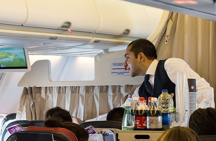 Flight attendant serving snacks