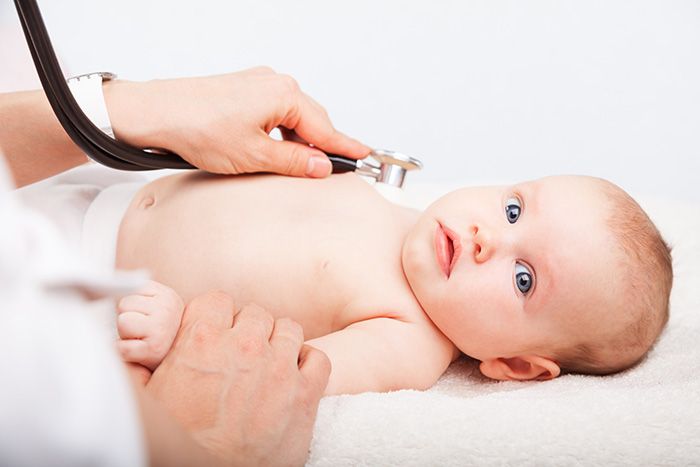 Doctor listening to baby's heart