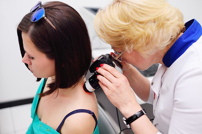 Dermatologist examining patient