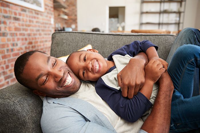 Dad snuggling with child
