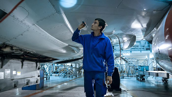 Technician inspects plan