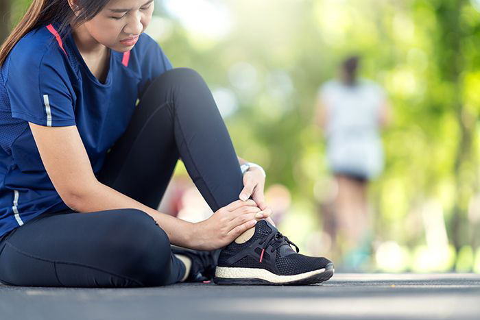 Image of woman messaging her ankle