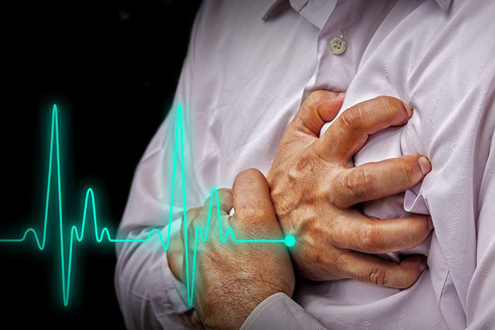 Man clutching chest