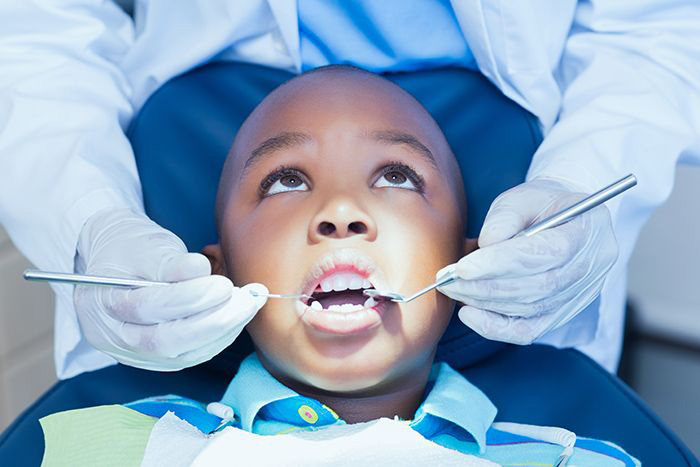 Dentist examining child's teeth.