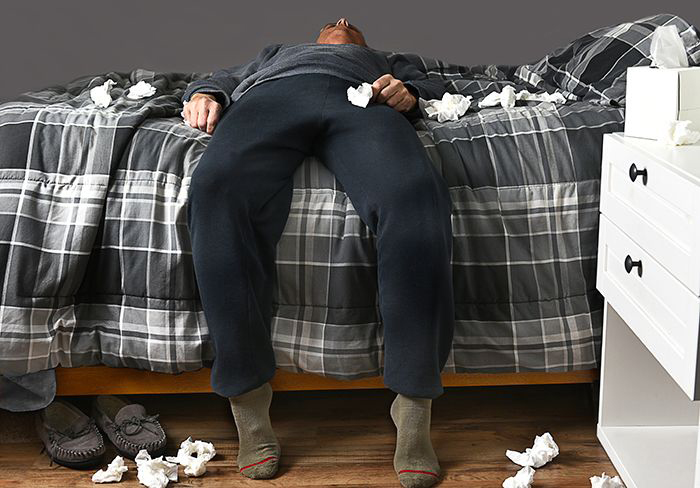 Image: Man with cold lying on a bed