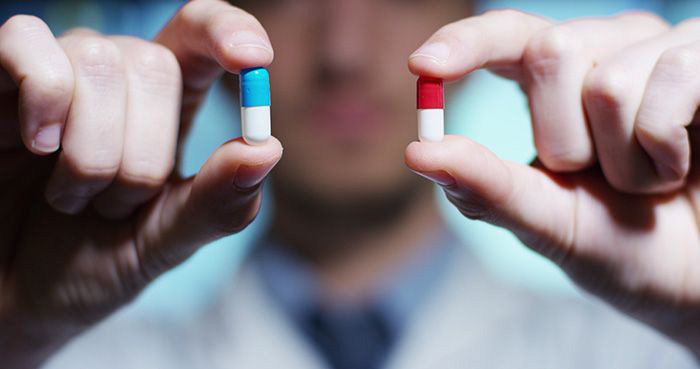 Doctor holds two nearly identical pills