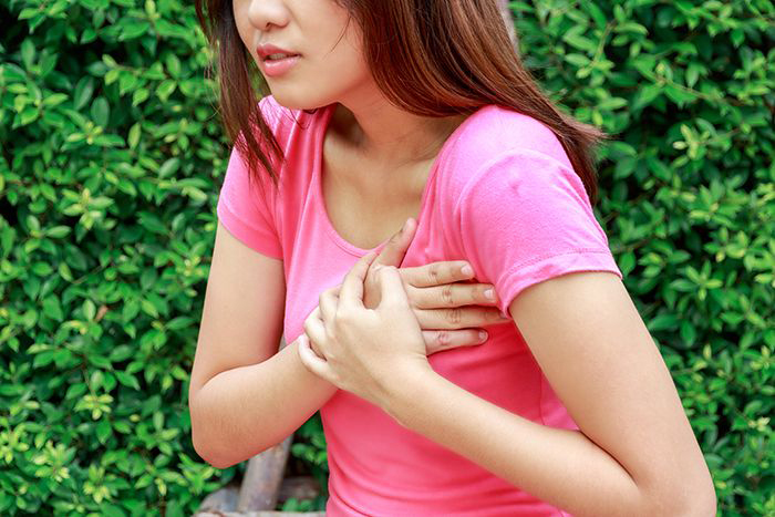 Image: Young woman suffering a heart attack